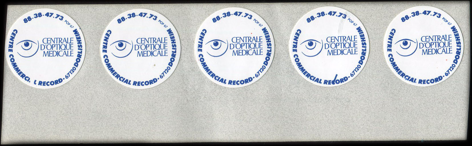 Fragment de feuille d'impression portant encore 5 autocollants Centrale d’Optique Médicale - Centre commercial Record - 67120 Dorlisheim - 88.38.47.73